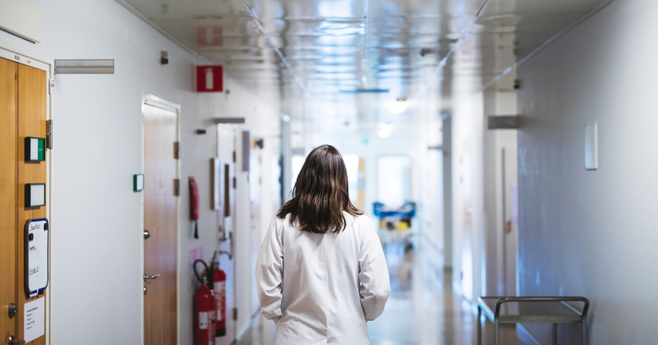 A Doctor walking through the hallways of a hospital
